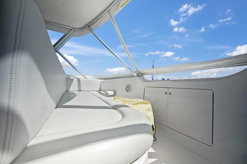 Tomaso 5 Yacht Photos Pics Interior view of 2004 Viking 52 Convertible yacht with white seating and blue sky.