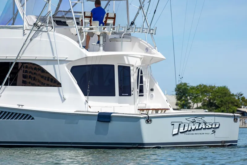 Tomaso 5 Yacht Photos Pics 2004 Viking 52 Convertible yacht on water, featuring "Tomaso" branding.