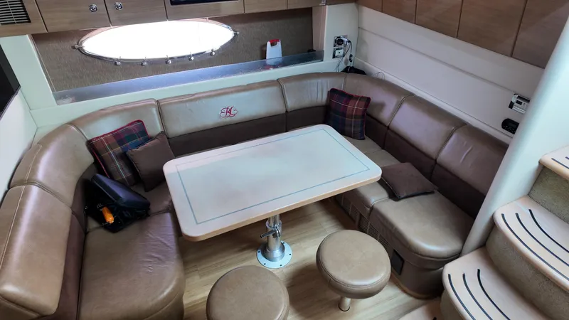 Royal Zenith Yacht Photos Pics Luxurious interior of a 2013 Formula 45 Yacht with leather seating and a central table.