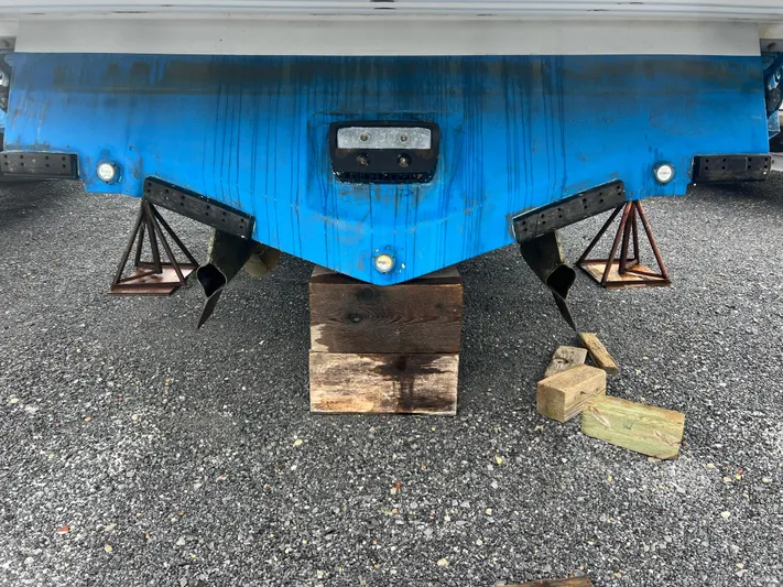 Royal Zenith Yacht Photos Pics Rear view of a 2013 Formula 45 Yacht on blocks, showing propellers and supports.