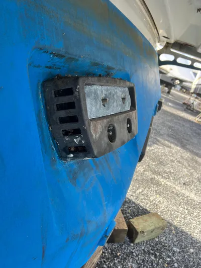 Royal Zenith Yacht Photos Pics Close-up of a 2013 Formula 45 Yacht hull with blue paint and metal fitting.