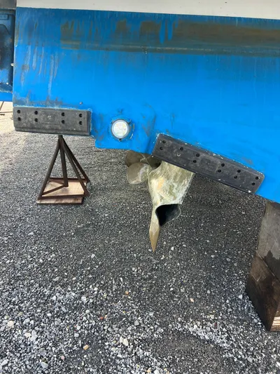 Royal Zenith Yacht Photos Pics 2013 Formula 45 Yacht underbody with propeller and blue hull on gravel.