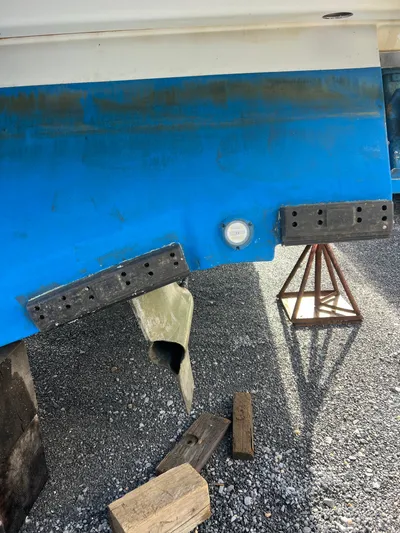 Royal Zenith Yacht Photos Pics 2013 Formula 45 Yacht hull on gravel, showing propeller and support stands.