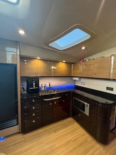 Royal Zenith Yacht Photos Pics Luxurious kitchen interior of 2013 Formula 45 Yacht with modern appliances and wood finish.