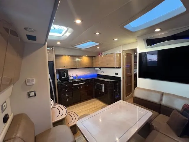 Royal Zenith Yacht Photos Pics Luxurious interior of a 2013 Formula 45 Yacht with modern kitchen and seating area.