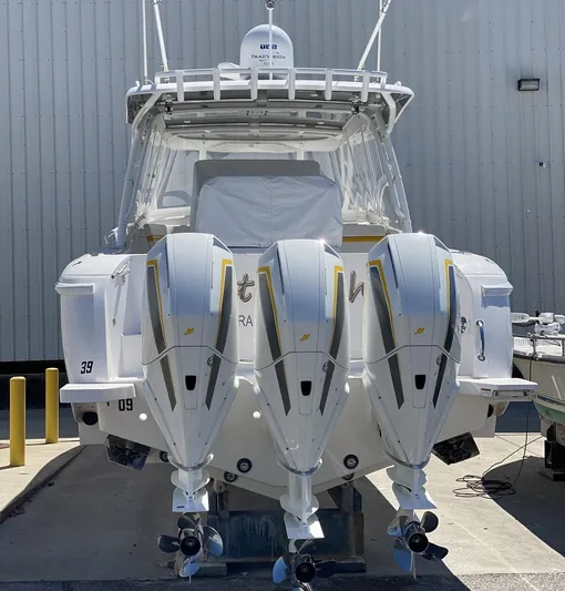  Yacht Photos Pics 2020 Intrepid 407 Cuddy boat with triple outboard engines, docked at a marina.
