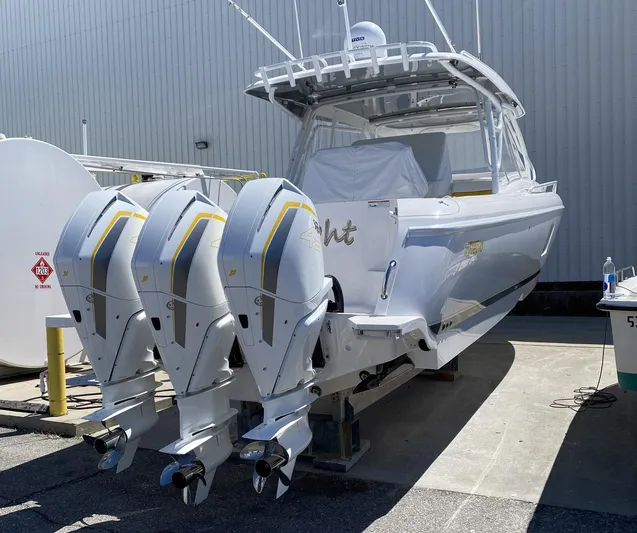  Yacht Photos Pics 2020 Intrepid 407 Cuddy boat with triple outboard engines, docked in a marina.