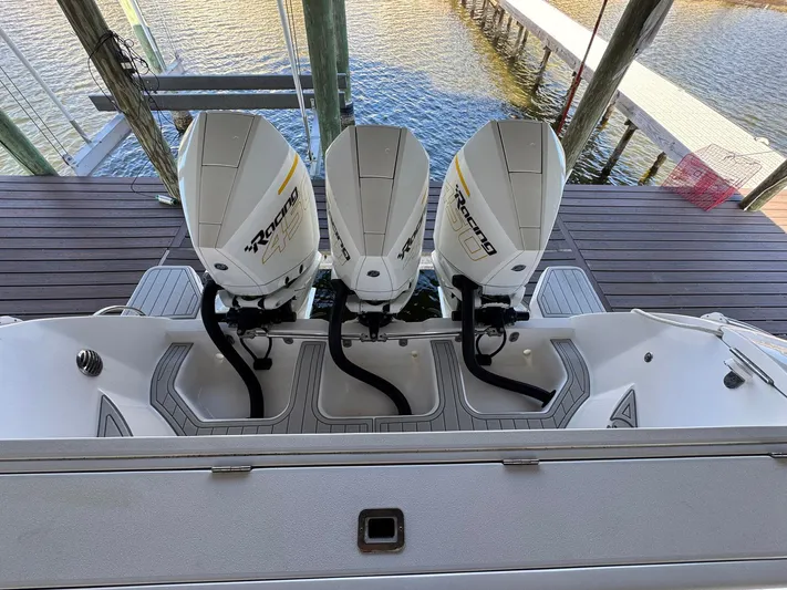  Yacht Photos Pics 2020 Intrepid 407 Cuddy with triple outboard engines docked by the water.