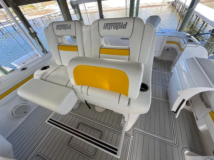  Yacht Photos Pics 2020 Intrepid 407 Cuddy boat interior with white and yellow seating.