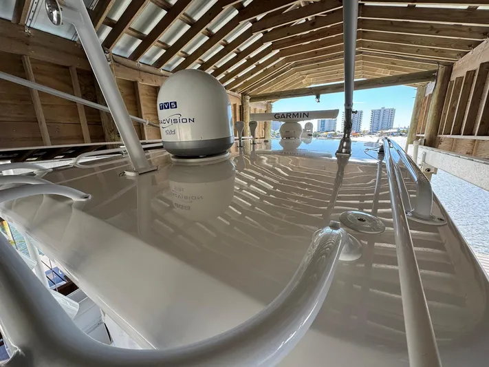  Yacht Photos Pics 2020 Intrepid 407 Cuddy boat roof with radar and navigation equipment in a wooden boathouse.