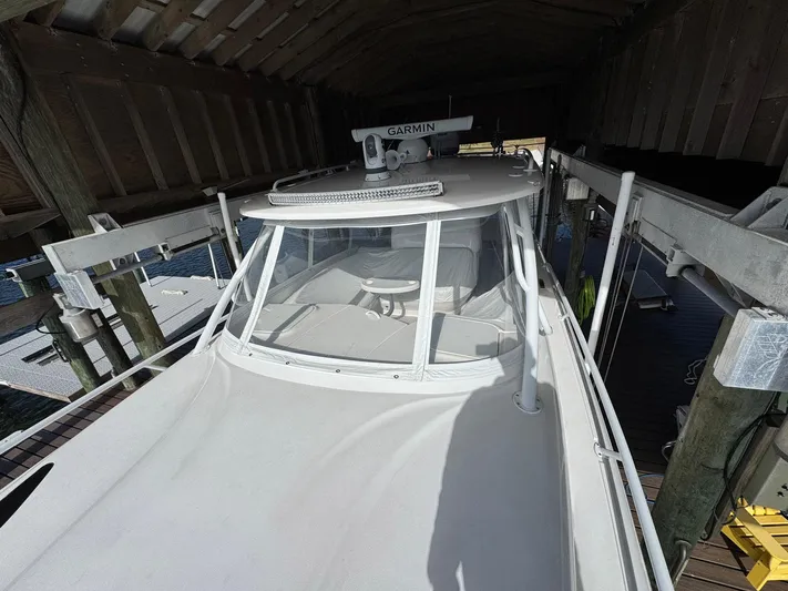  Yacht Photos Pics 2020 Intrepid 407 Cuddy boat docked under shelter, featuring Garmin equipment.