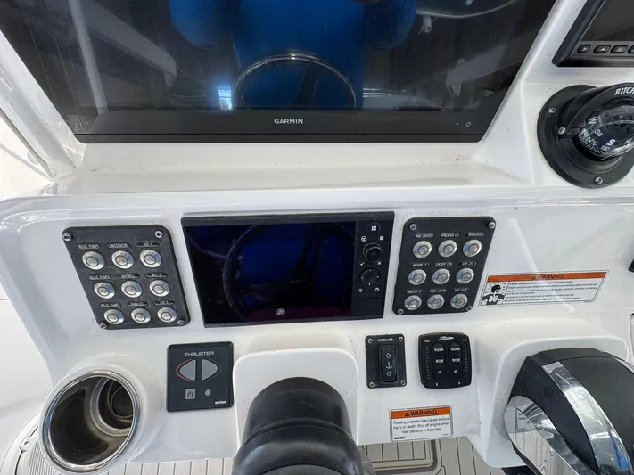  Yacht Photos Pics Control panel of a 2020 Intrepid 407 Cuddy boat with navigation and throttle controls.