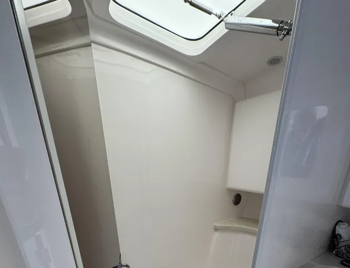  Yacht Photos Pics Interior of 2020 Intrepid 407 Cuddy boat, featuring sleek white cabin design.