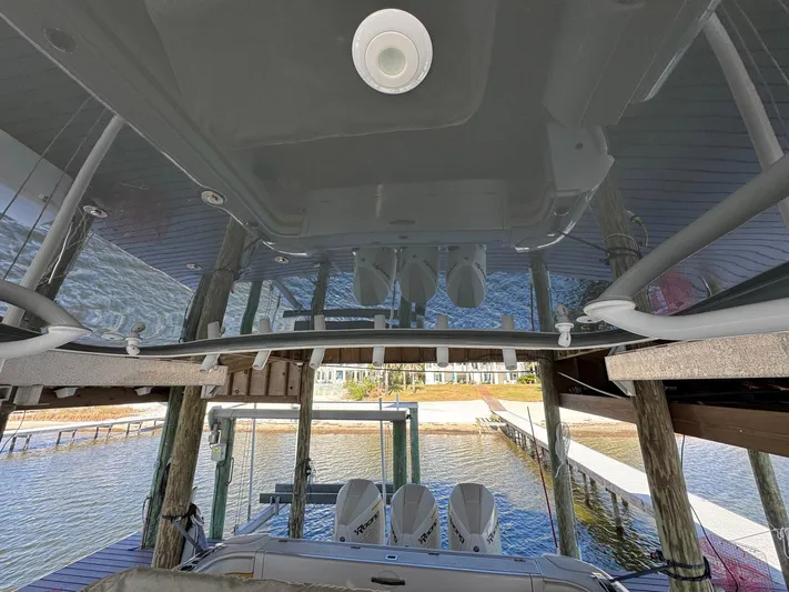  Yacht Photos Pics 2020 Intrepid 407 Cuddy boat docked, featuring triple outboard engines and sleek design.