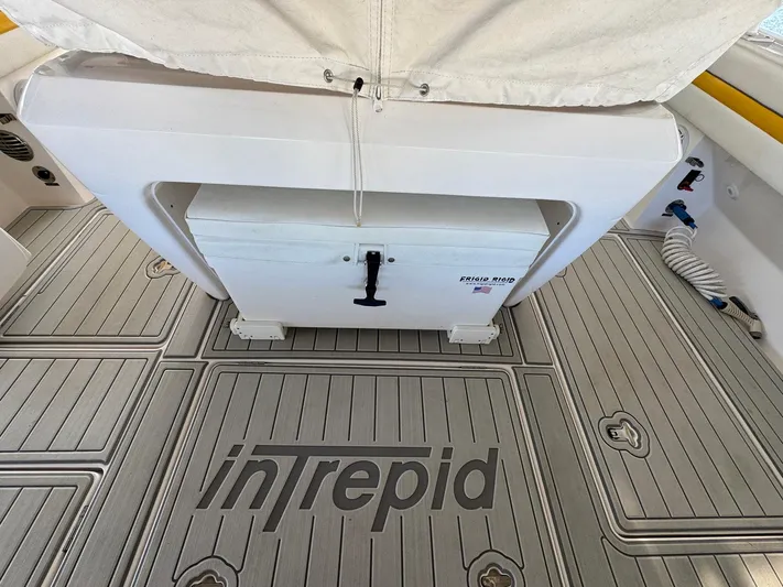  Yacht Photos Pics 2020 Intrepid 407 Cuddy boat deck with branded flooring and storage compartment.