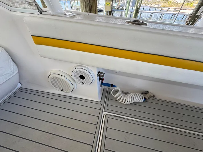  Yacht Photos Pics 2020 Intrepid 407 Cuddy boat interior with speakers and coiled hose on deck.