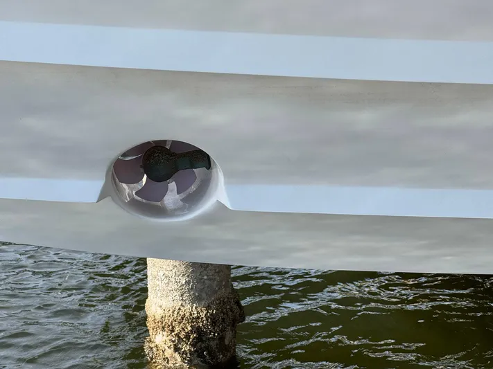  Yacht Photos Pics 2020 Intrepid 407 Cuddy boat hull with thruster, docked near a concrete pillar.