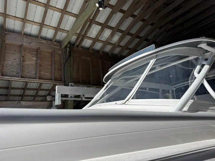  Yacht Photos Pics 2020 Intrepid 407 Cuddy boat in a wooden boathouse, partial view.