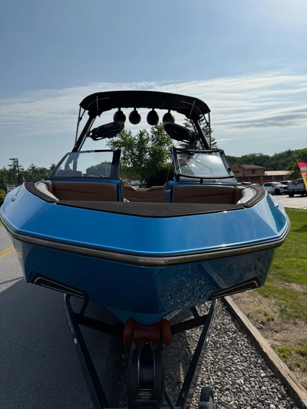 2022 Axis T250 boat in blue, parked on a trailer, front view.