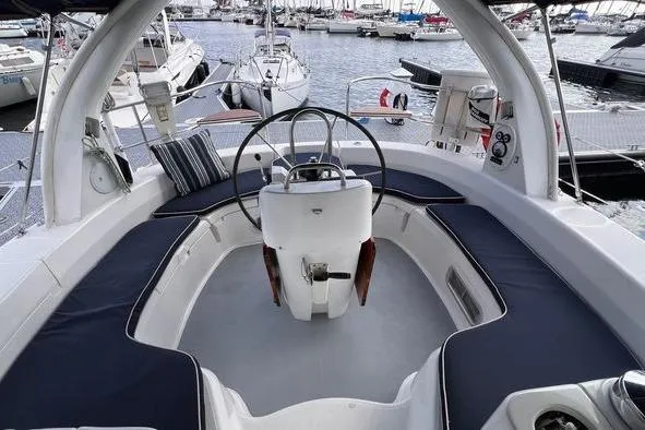  Yacht Photos Pics Cockpit of 1999 Hunter 410 sailboat with steering wheel, docked in marina.