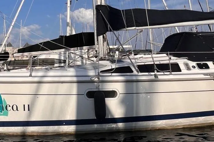  Yacht Photos Pics 1999 Hunter 410 sailboat docked at marina, featuring sleek design and black sail covers.