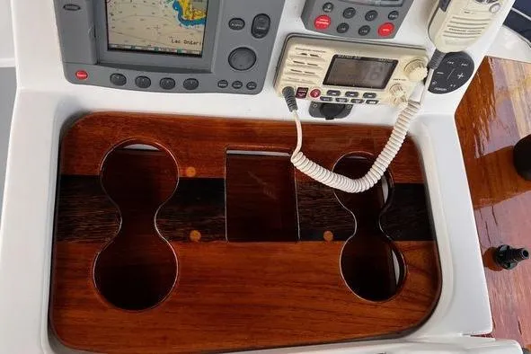 Yacht Photos Pics Control panel of a 1999 Hunter 410 boat with navigation equipment and wooden cup holders.