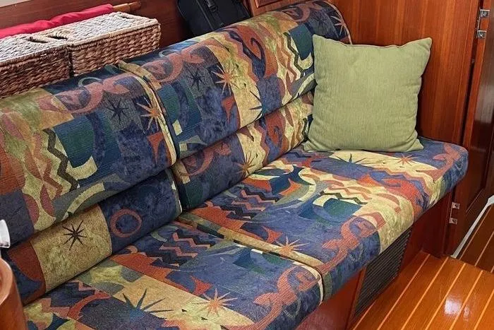  Yacht Photos Pics Colorful patterned sofa with green pillow in 1999 Hunter 410 interior.