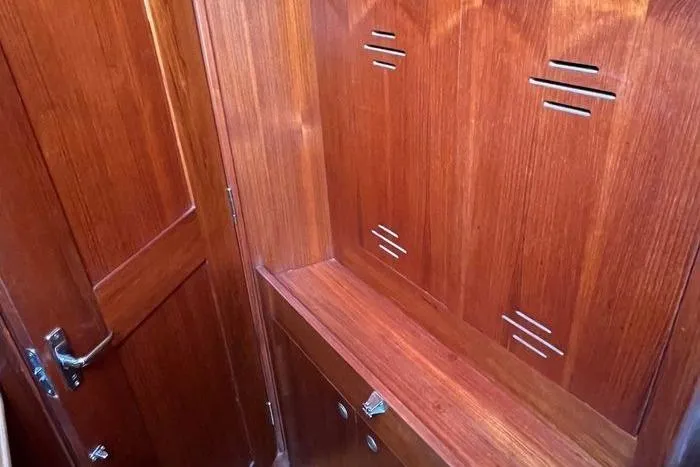  Yacht Photos Pics Wooden interior of a 1999 Hunter 410 yacht, featuring storage compartments and sleek design.