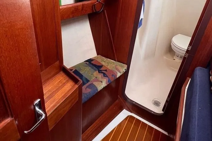  Yacht Photos Pics Interior of 1999 Hunter 410 sailboat with wooden finish and compact bathroom.