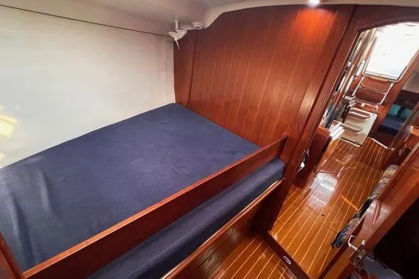  Yacht Photos Pics Interior cabin of 1999 Hunter 410 sailboat with wooden finish and blue bedding.