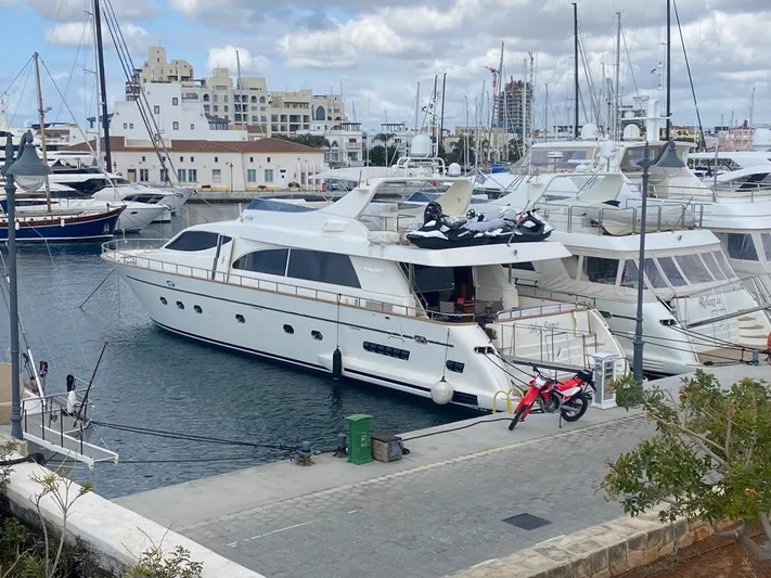 My Sons Yacht Photos Pics Luxury Falcon 86 yacht docked in marina, 2008 model, with jet skis and motorcycle on deck.