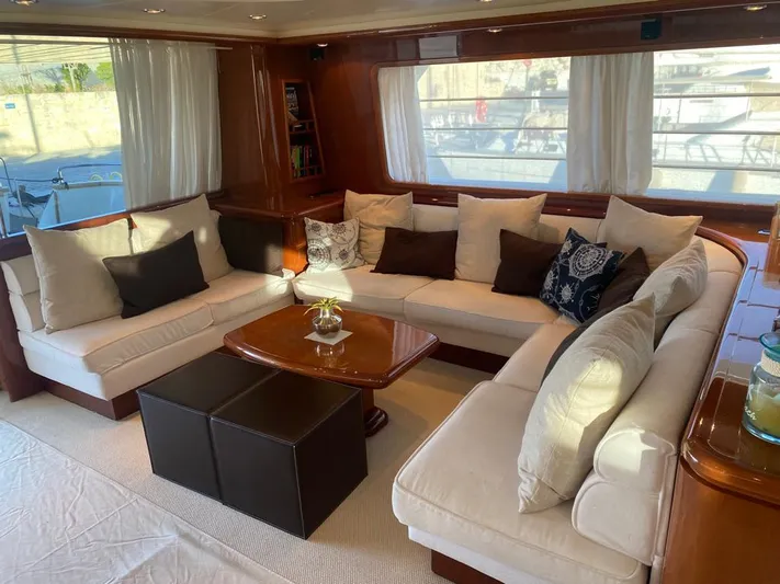 My Sons Yacht Photos Pics Luxurious yacht interior with cream sofas, dark cushions, and a wooden table, Falcon 86, 2008 model.