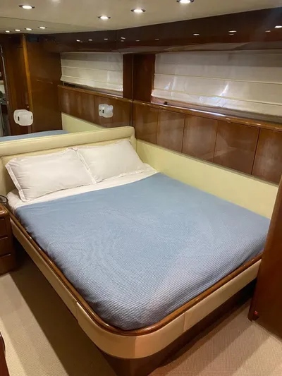 My Sons Yacht Photos Pics Luxurious bedroom in 2008 Falcon 86 yacht with elegant wood paneling and cozy bedding.