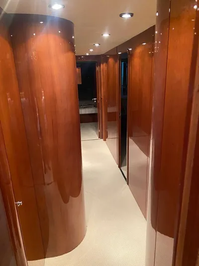 My Sons Yacht Photos Pics Luxurious hallway in 2008 Falcon 86 yacht with polished wood paneling and recessed lighting.