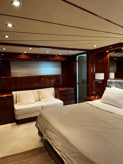 My Sons Yacht Photos Pics Luxurious bedroom interior on 2008 Falcon 86 yacht, featuring elegant wood paneling and modern lighting.