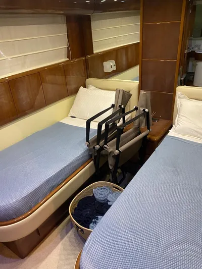 My Sons Yacht Photos Pics Twin beds in a 2008 Falcon 86 yacht cabin with blue bedding and wooden accents.