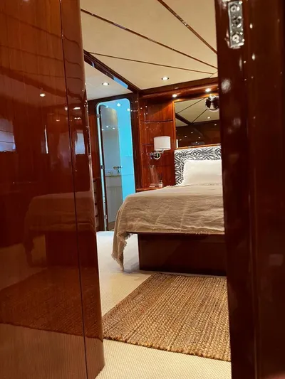 My Sons Yacht Photos Pics Luxurious bedroom interior on a 2008 Falcon 86 yacht, featuring elegant wood paneling.