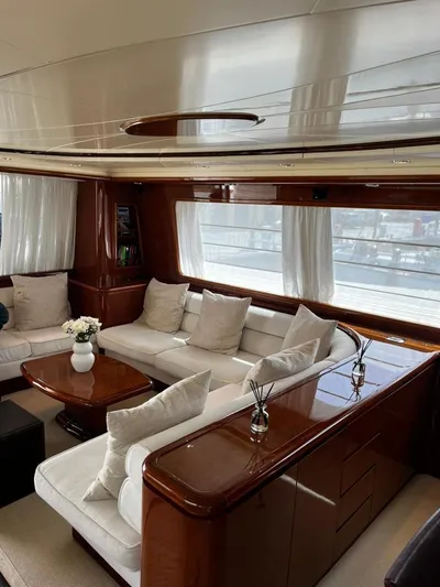 My Sons Yacht Photos Pics Luxurious interior of a 2008 Falcon 86 yacht with elegant seating and wooden accents.