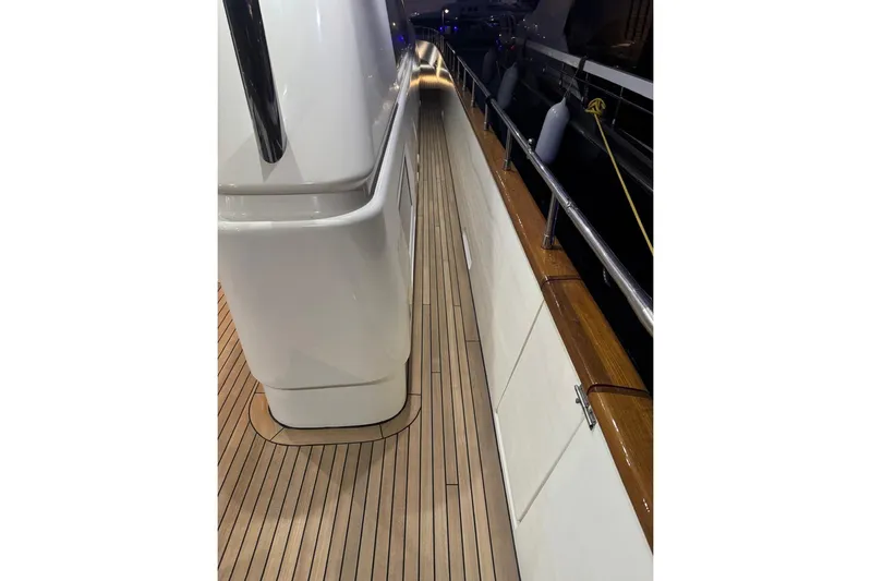 My Sons Yacht Photos Pics Side deck of 2008 Falcon 86 yacht with wooden flooring and railing.