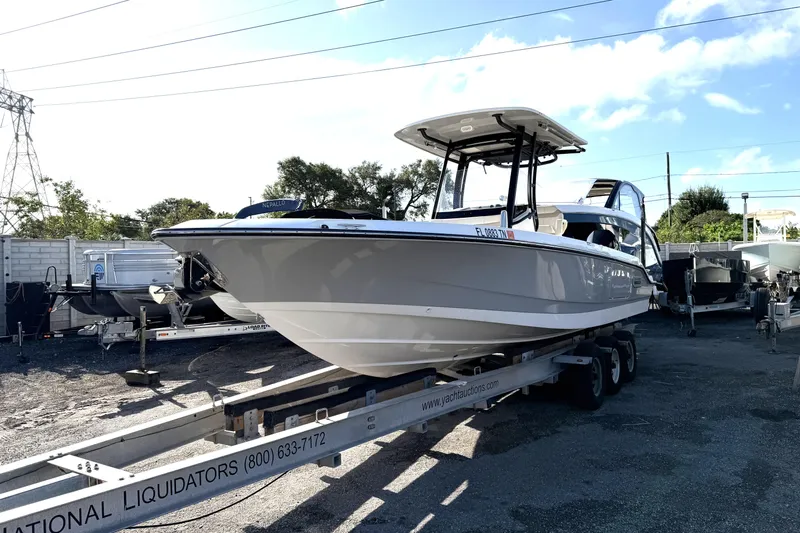  Yacht Photos Pics 2023 Boston Whaler 280 Dauntless boat on trailer in outdoor lot.