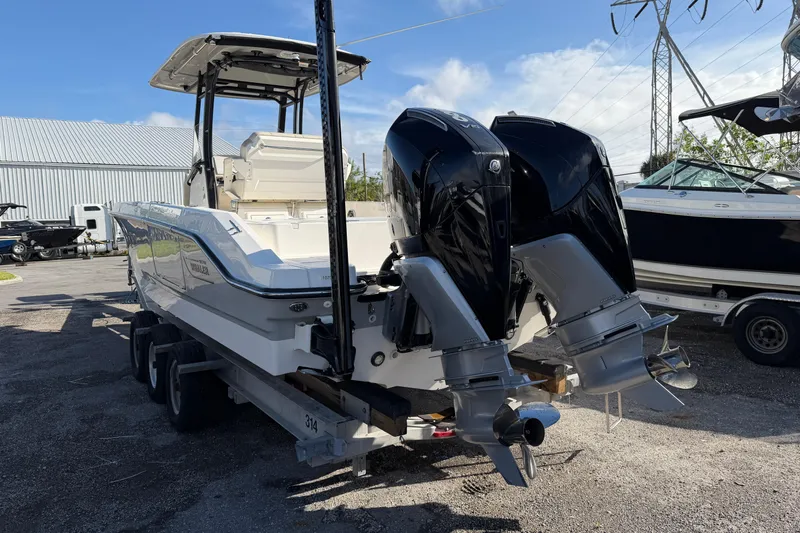  Yacht Photos Pics 2023 Boston Whaler 280 Dauntless boat with dual outboard engines on a trailer.
