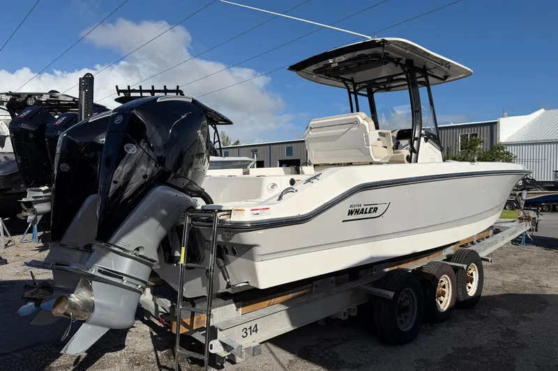  Yacht Photos Pics 2023 Boston Whaler 280 Dauntless boat on trailer, featuring dual outboard engines.