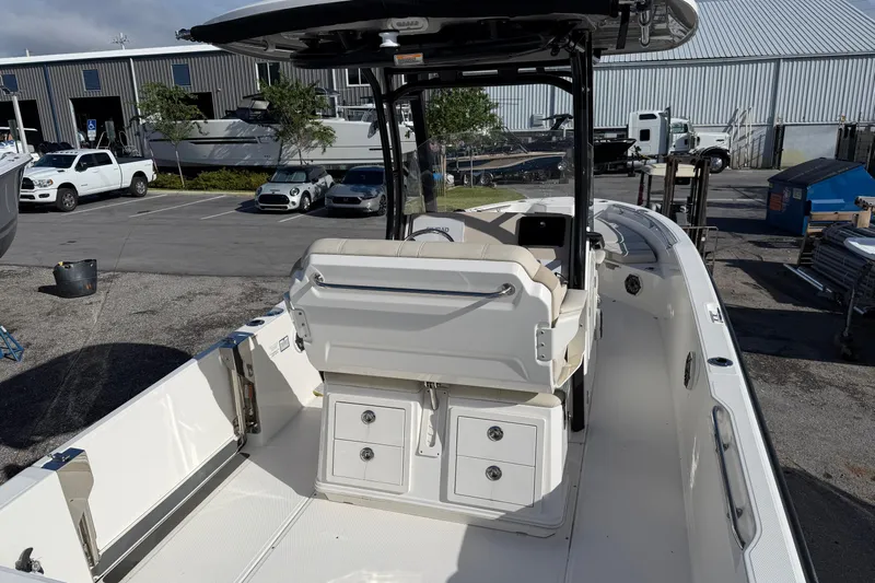  Yacht Photos Pics 2023 Boston Whaler 280 Dauntless boat interior with seating and storage, parked outdoors.