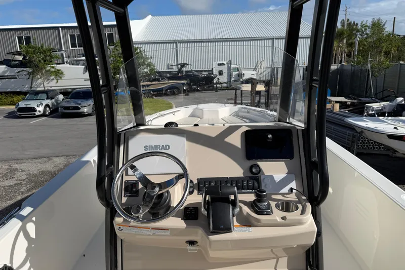  Yacht Photos Pics 2023 Boston Whaler 280 Dauntless boat dashboard with steering wheel and controls.
