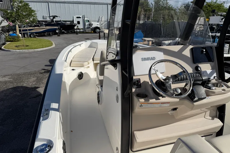  Yacht Photos Pics 2023 Boston Whaler 280 Dauntless boat interior with steering console and seating area.