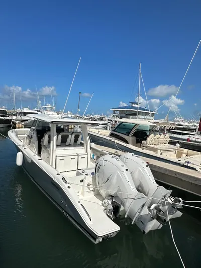  Yacht Photos Pics 2023 Pursuit S 358 Sport boat docked in marina under clear blue sky.