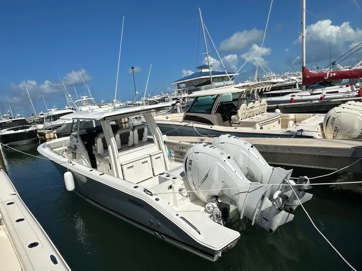  Yacht Photos Pics 2023 Pursuit S 358 Sport boat docked in marina under clear blue sky.