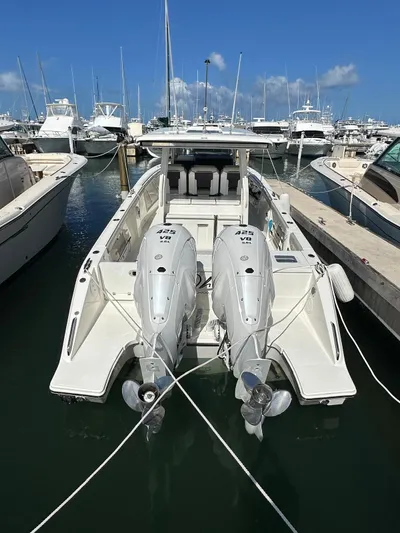  Yacht Photos Pics 2023 Pursuit S 358 Sport boat docked with twin engines in a marina.