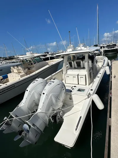  Yacht Photos Pics 2023 Pursuit S 358 Sport boat docked with twin outboard engines.
