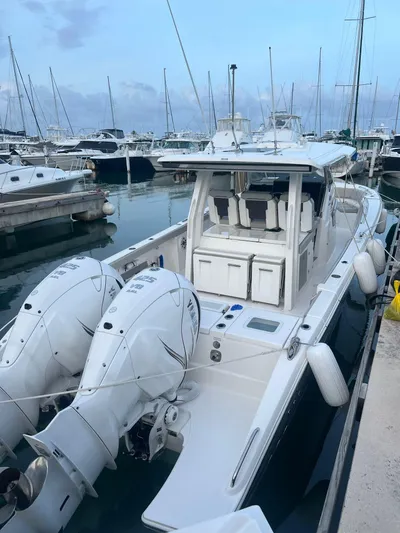  Yacht Photos Pics 2023 Pursuit S 358 Sport boat docked in marina with twin engines.